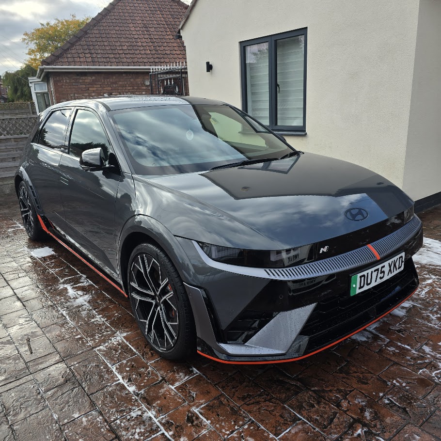 Hyundai car undergoing mobile valeting service, showcasing clean exterior with premium wax finish on driveway.